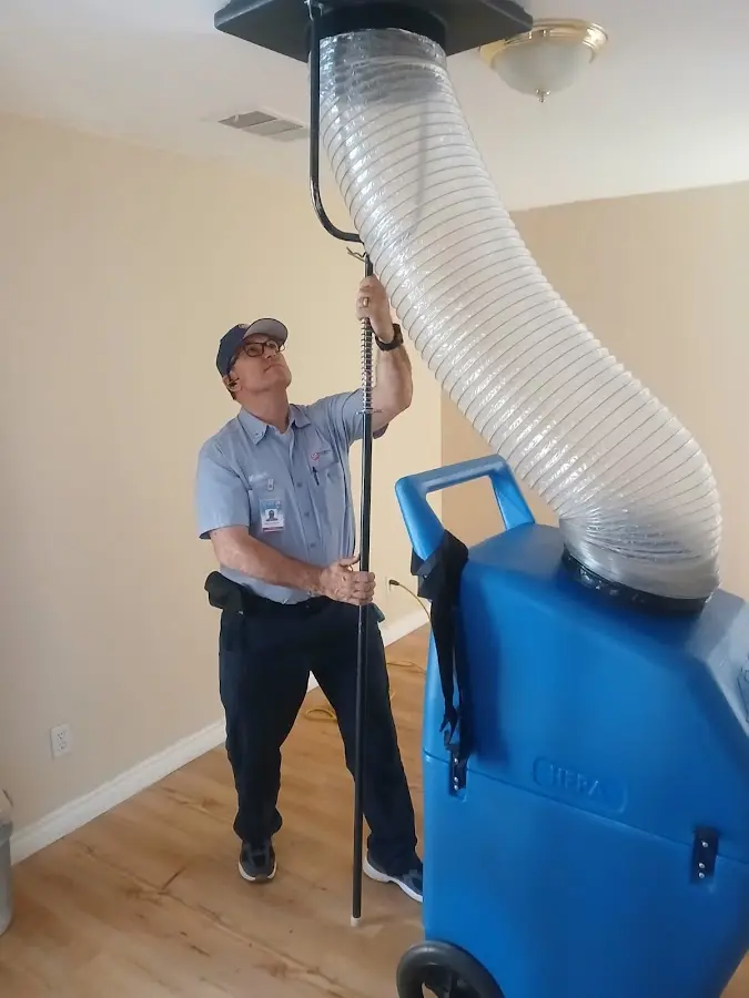 Furnace Tune-Up technician using HEPA equipment in Celebration