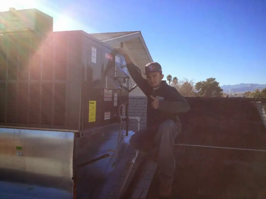 HVAC technician performing Heat Pump Repair on a rooftop unit in Celebration